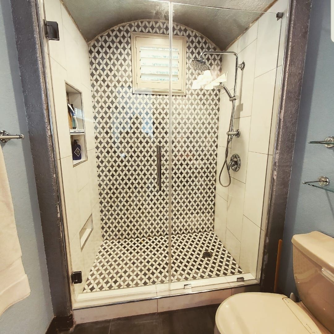 A bathroom with a walk in shower and a toilet