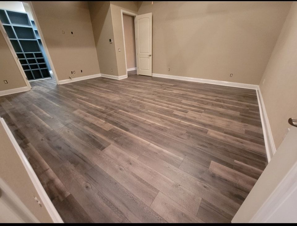 An empty room with hardwood floors and a walk in closet.