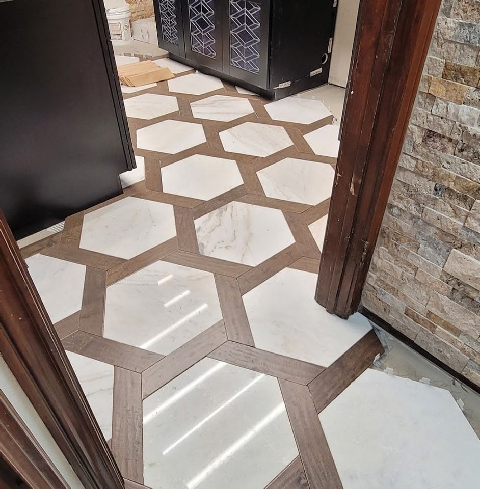 A hallway with a marble floor and a wooden door