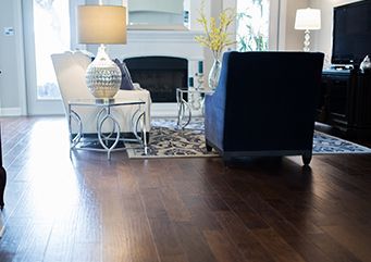 A living room with hardwood floors and a fireplace.