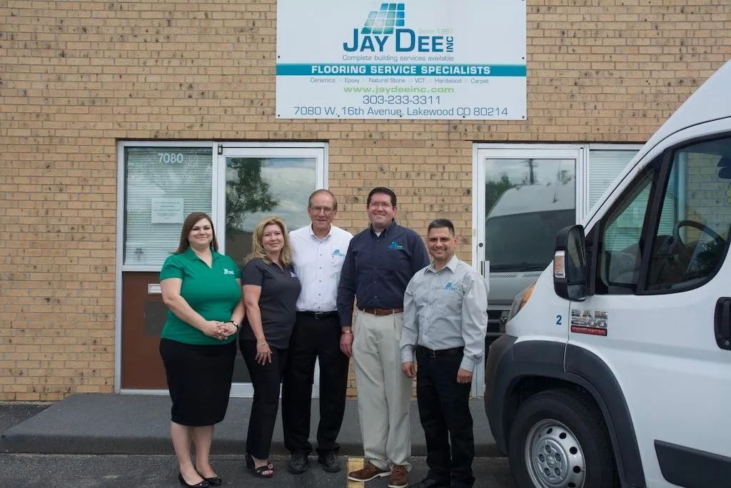 Group of five people outside a building with the