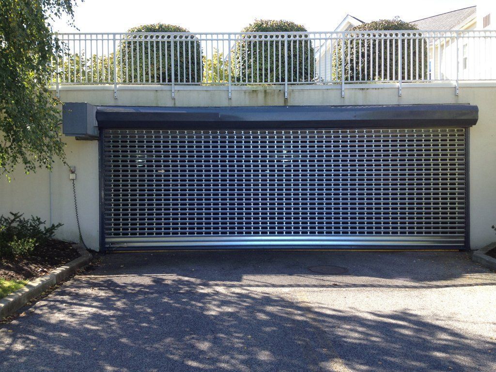 A large garage door with a railing behind it