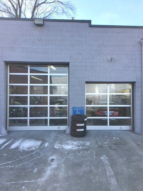 A garage door with a barrel in front of it