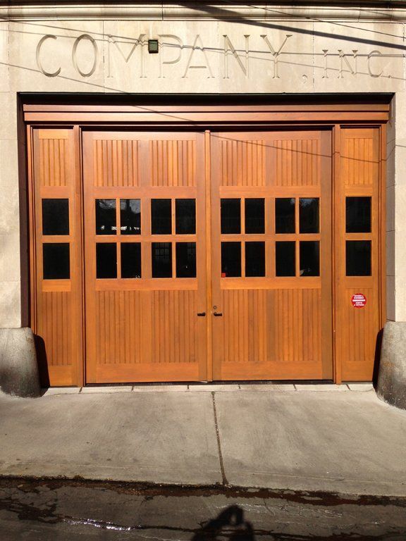 A large wooden garage door with the word company written on it