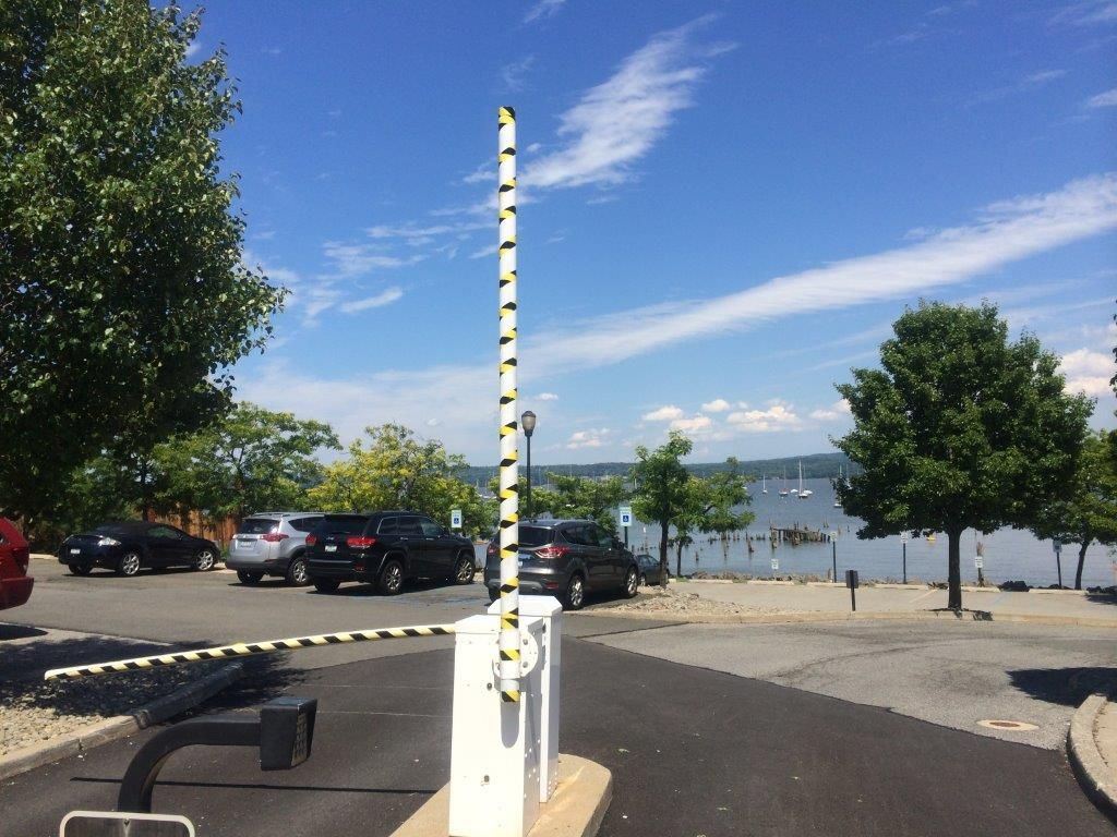A parking lot with cars parked in front of a body of water