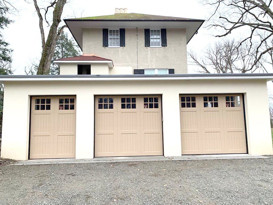 A house with three garage doors on the side of it