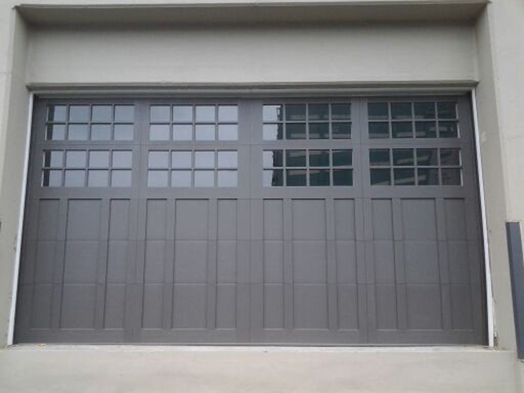 A gray garage door with a lot of windows