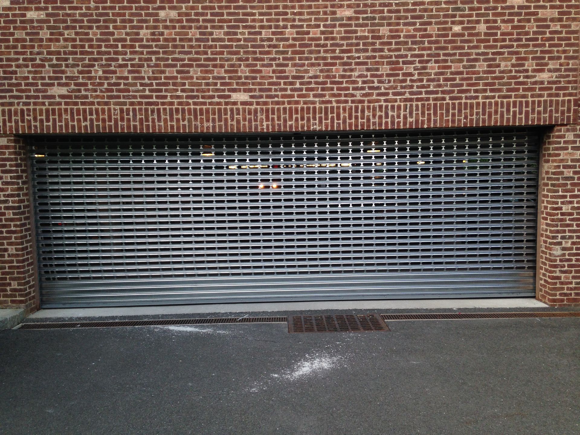 A garage door with a brick wall behind it