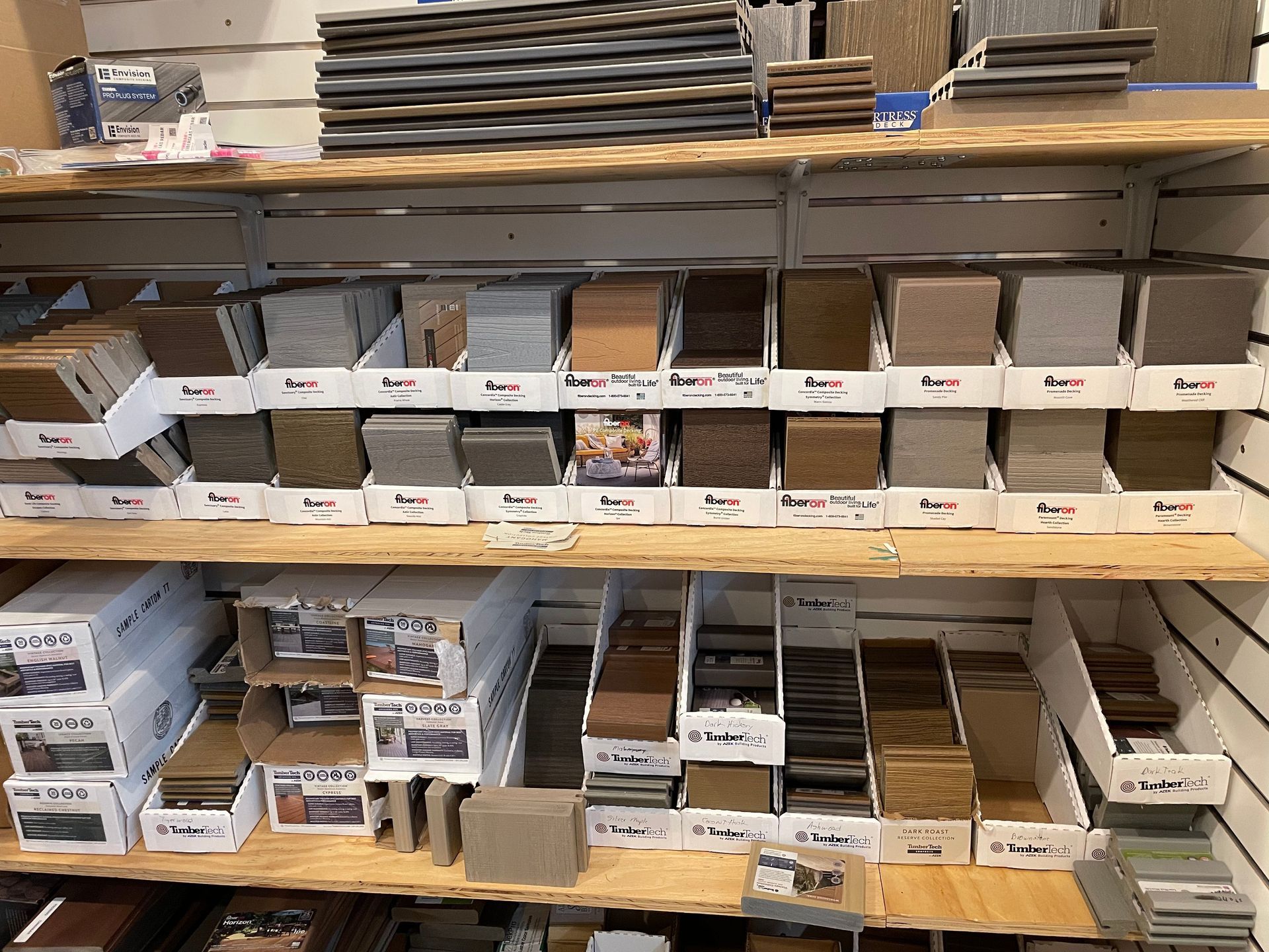 Shelves stocked with various tile samples in a store, showcasing different colors and textures.