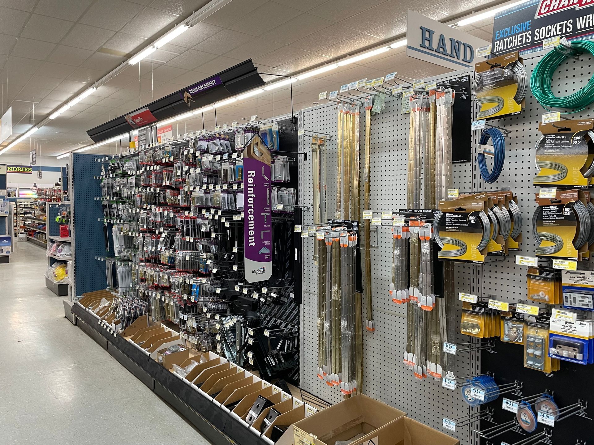 Fishing gear and supplies for sale in a retail store, including rods, lures, and line.