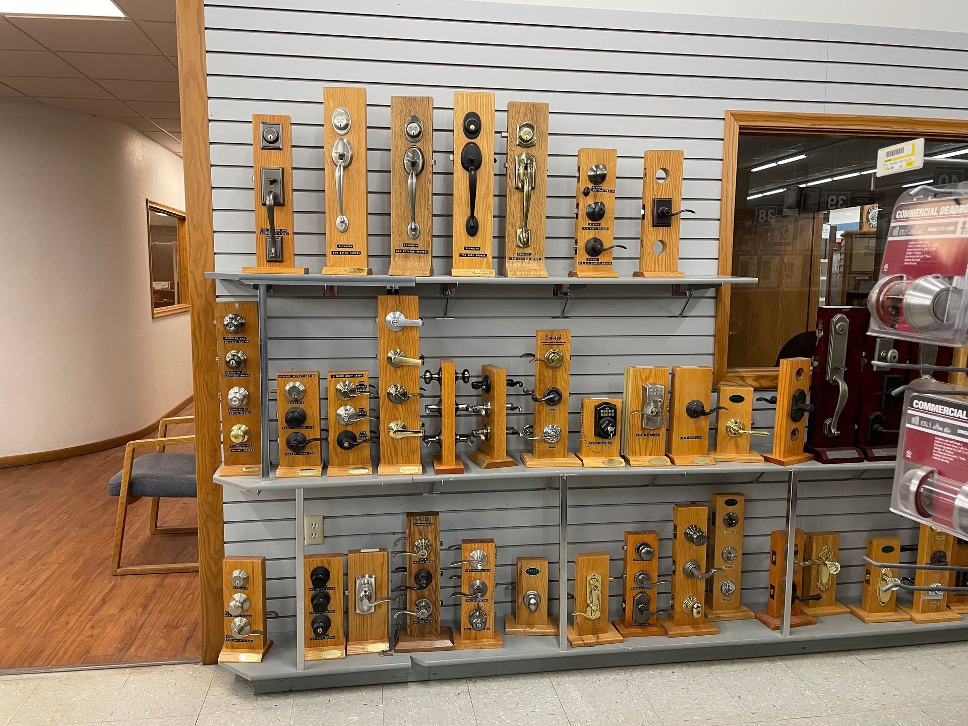 Shelves displaying various door knobs and locks inside a store.