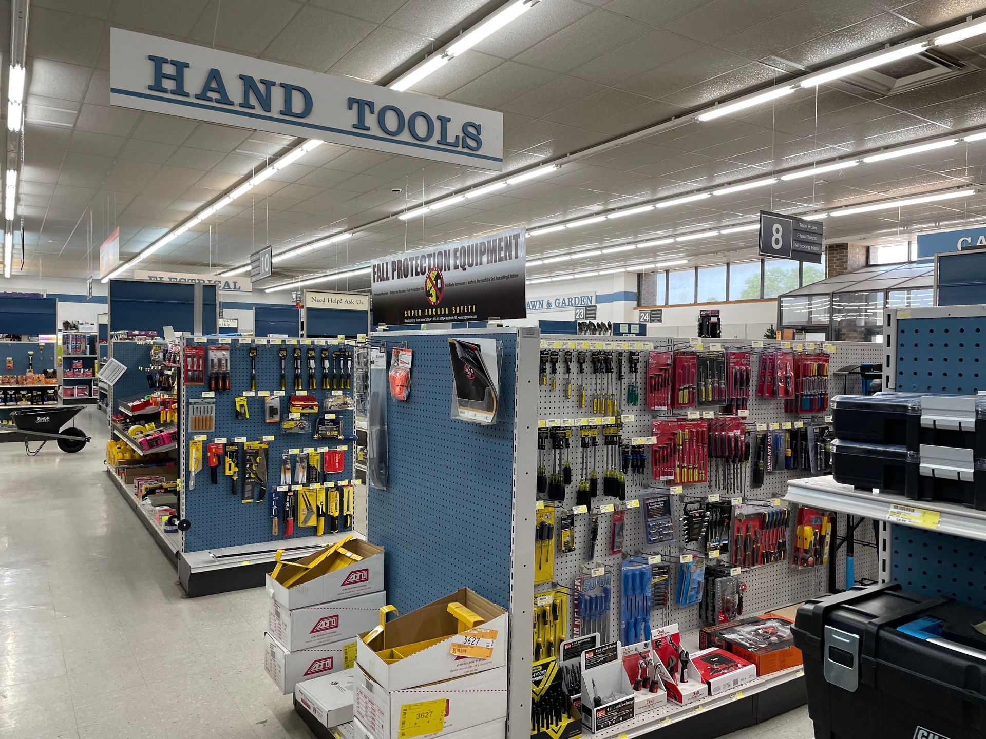 Hardware store aisle with hand tools on display under a 