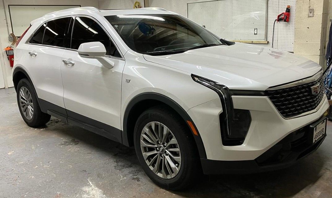 A white car is parked in a garage.