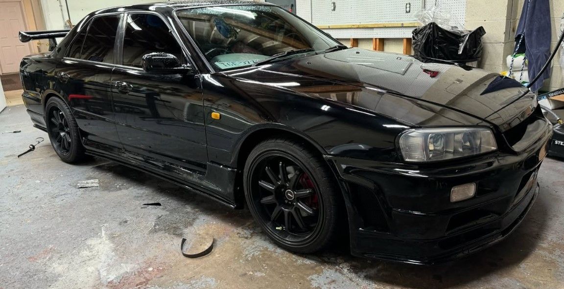 A black car is parked in a garage.