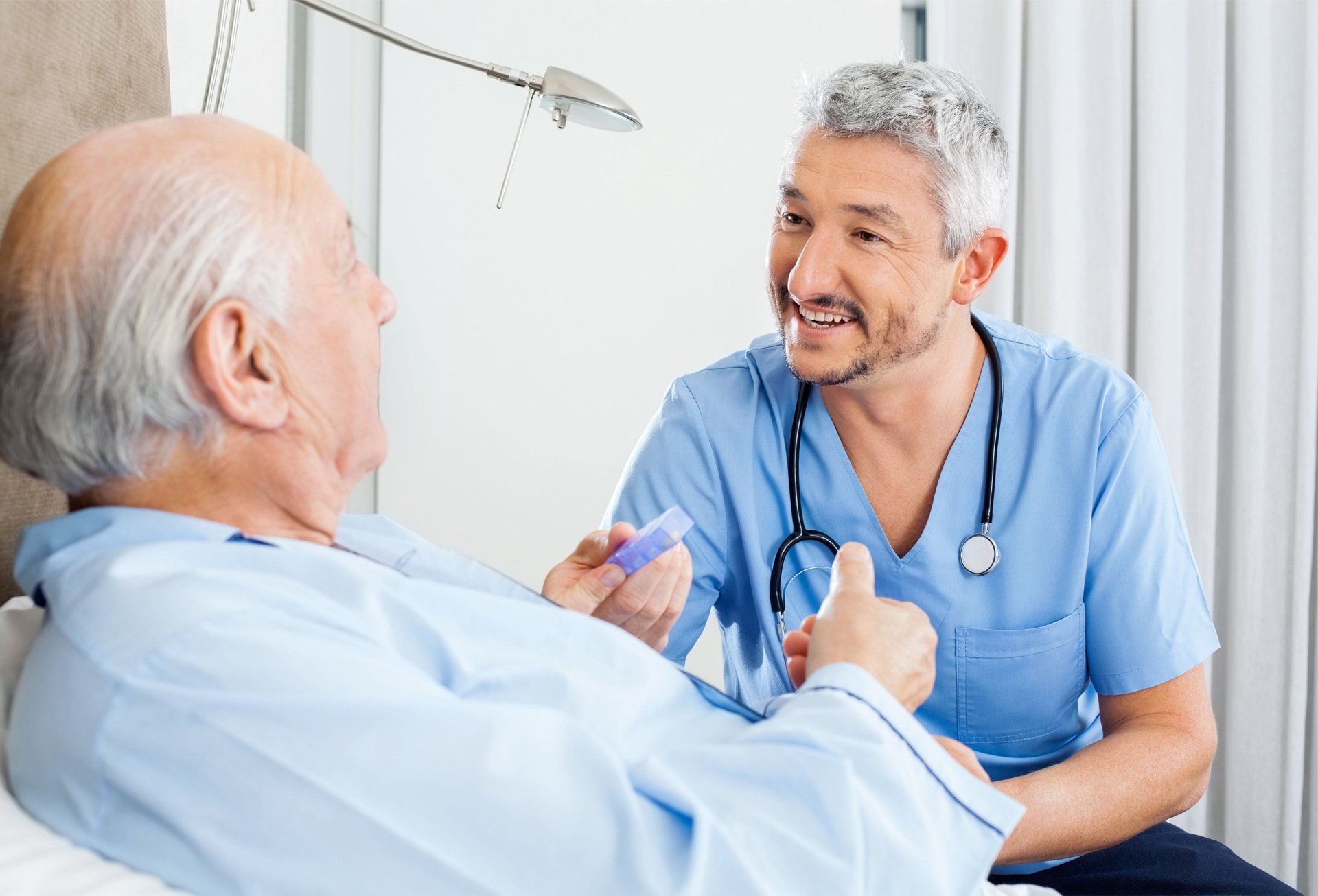 Doctor giving medicine to an elderly man