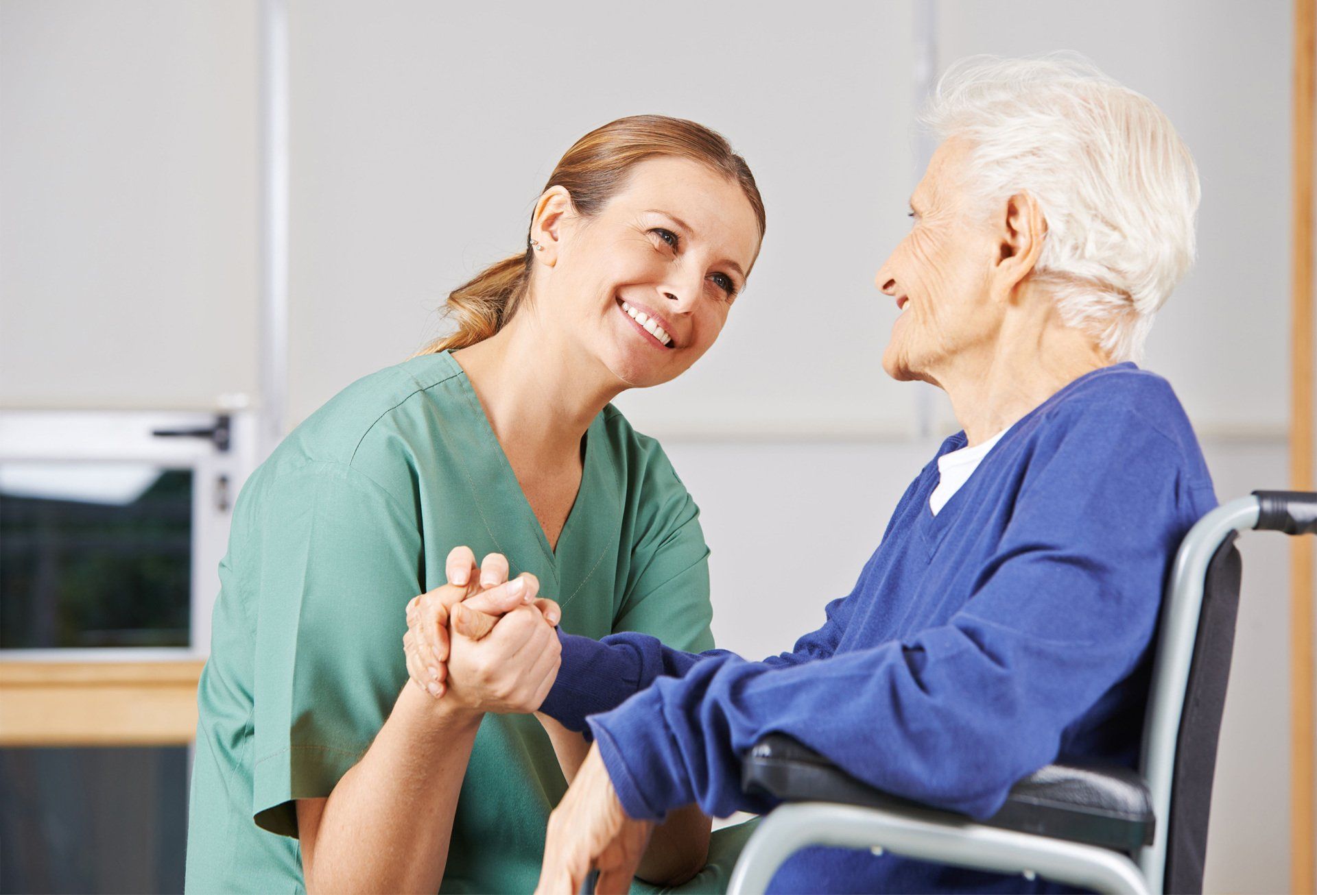 Smiling nurse to her elderly patient