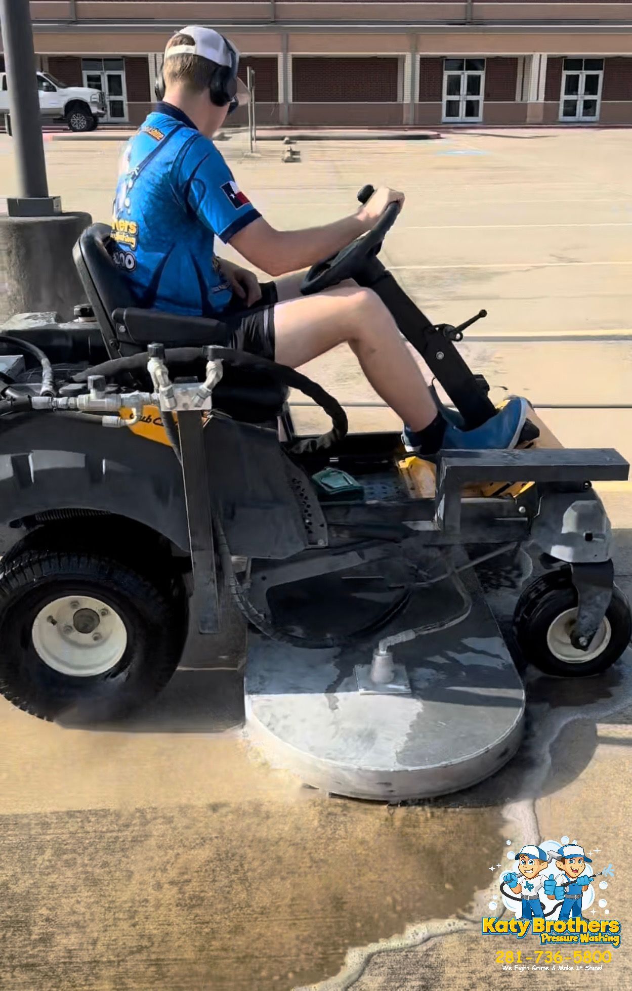 Person in a blue shirt driving a mobility scooter over a concrete obstacle in a parking lot