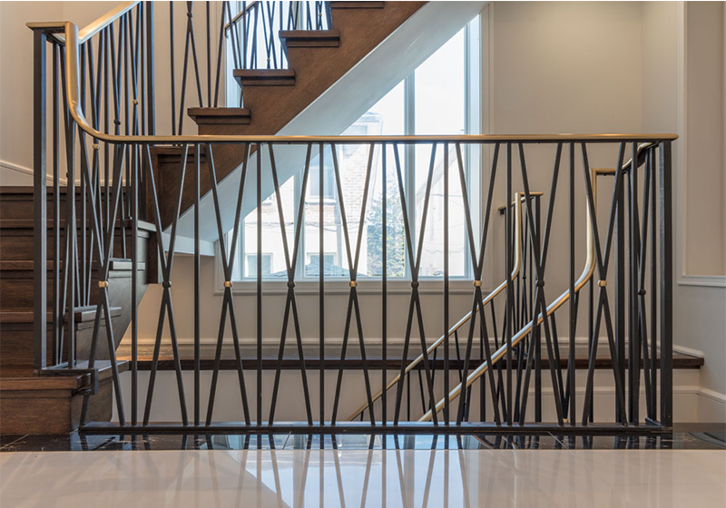 A staircase with lights on the steps and a glass railing