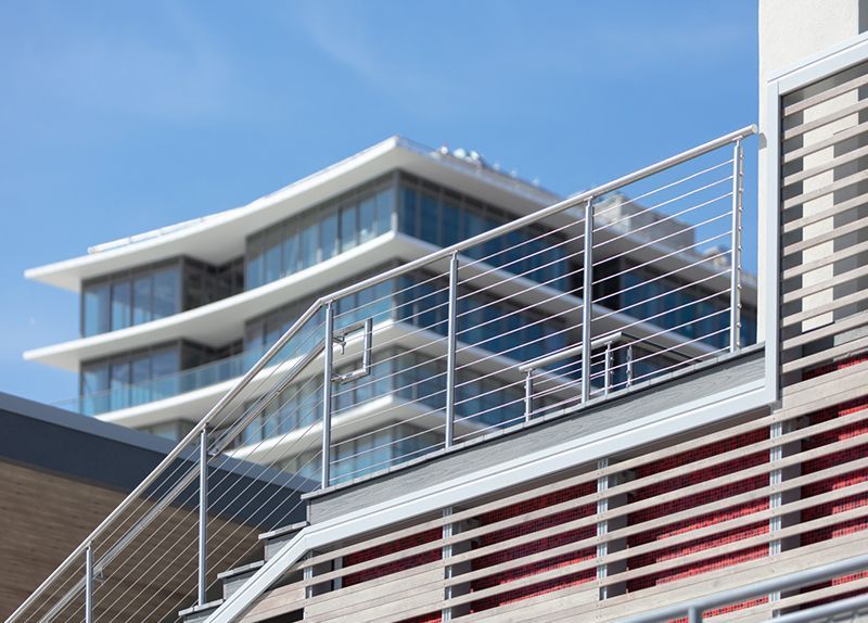 A staircase leading up to a balcony on the side of a building.