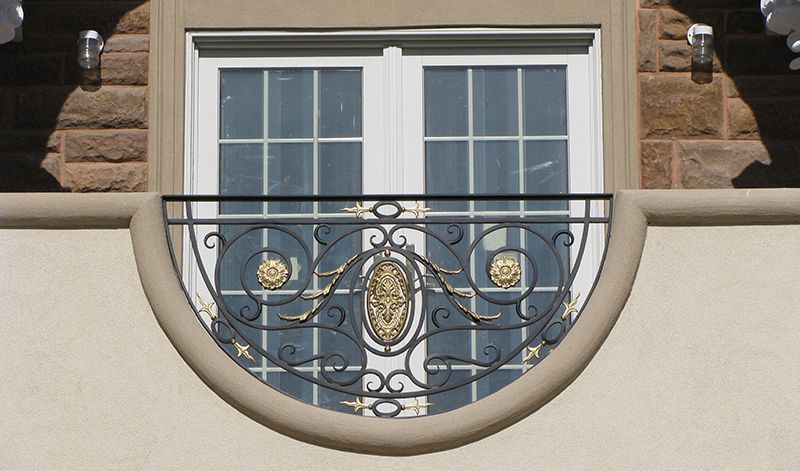 A window with a wrought iron railing around it