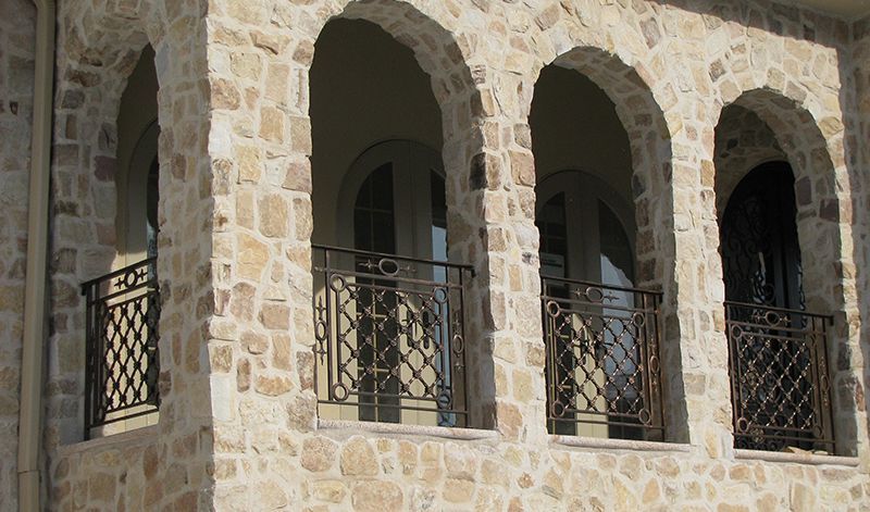 A stone building with arches and balconies on it