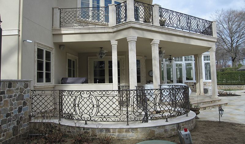 A large house with a balcony and a grill on it.