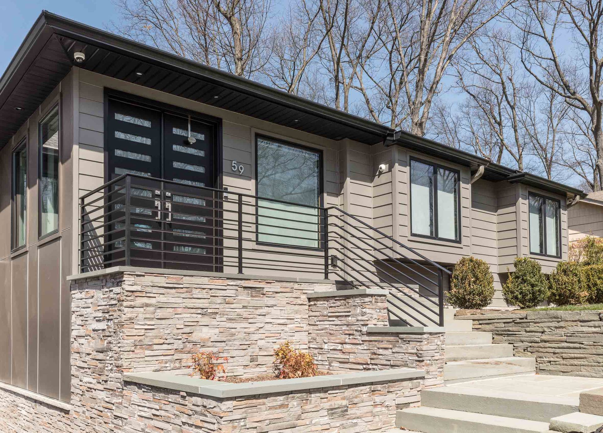 A house with stairs leading up to it and a balcony