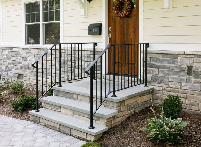 The front porch of a house with new aluminum railing.