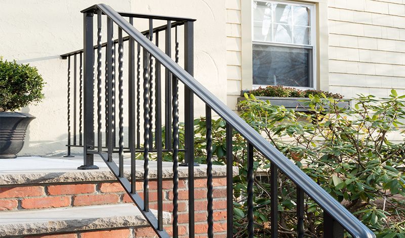 A wrought iron railing on the steps of a house