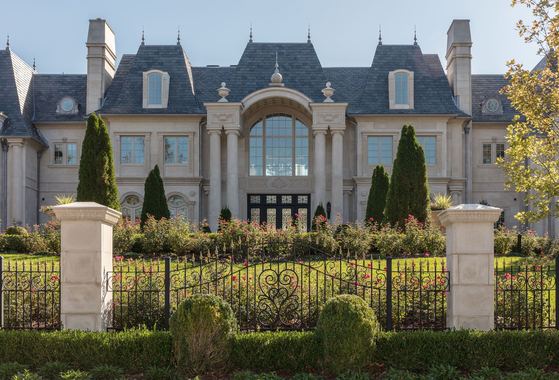 A large house with a fence in front of it