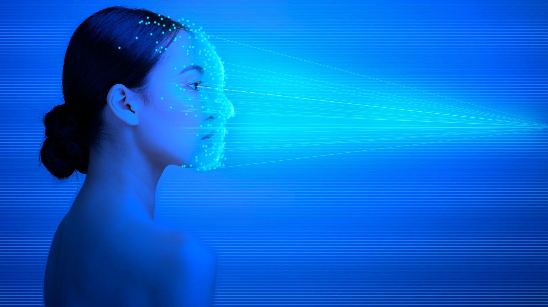 Woman's face in profile, illuminated with blue light, overlaid with a mesh grid; blue beams extending outward, set against a blue-lined background.