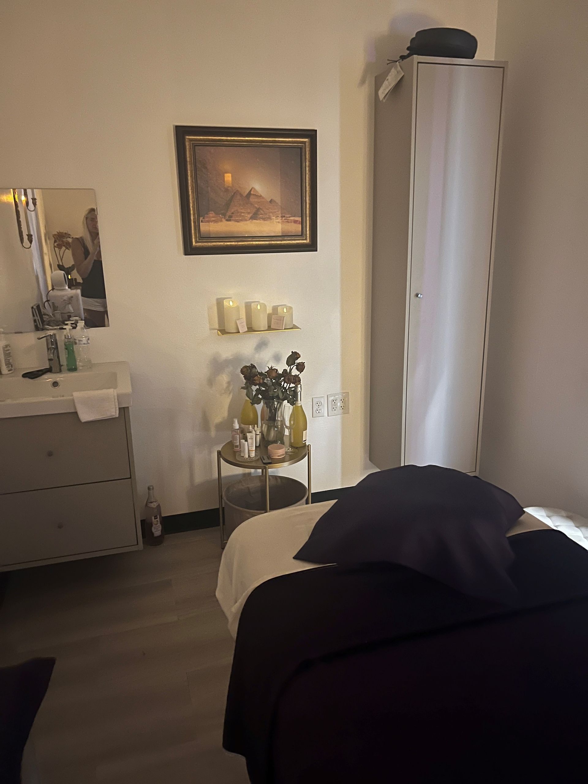 A room with a bed and a picture on the wall