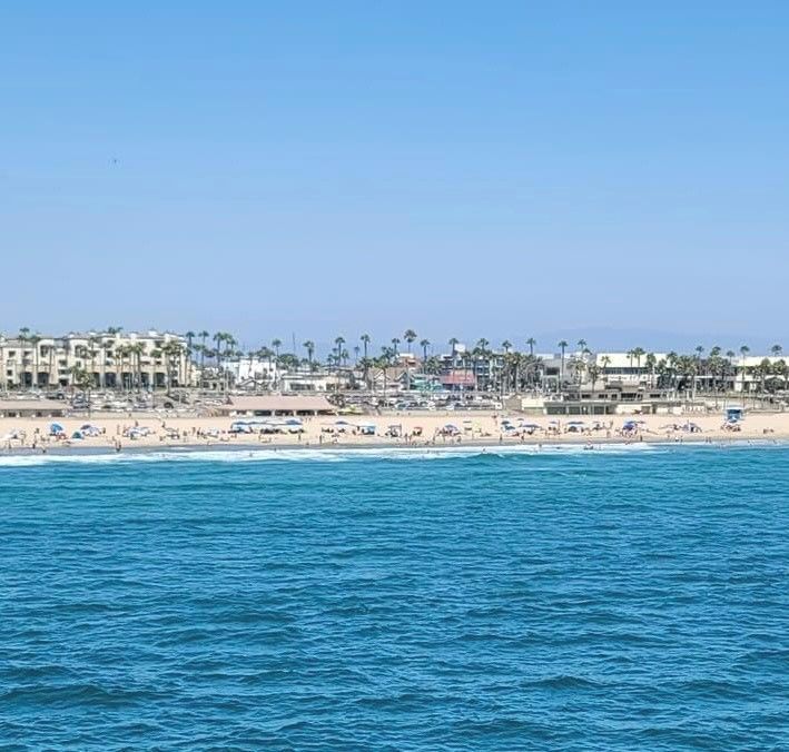 A large body of water with a beach in the background