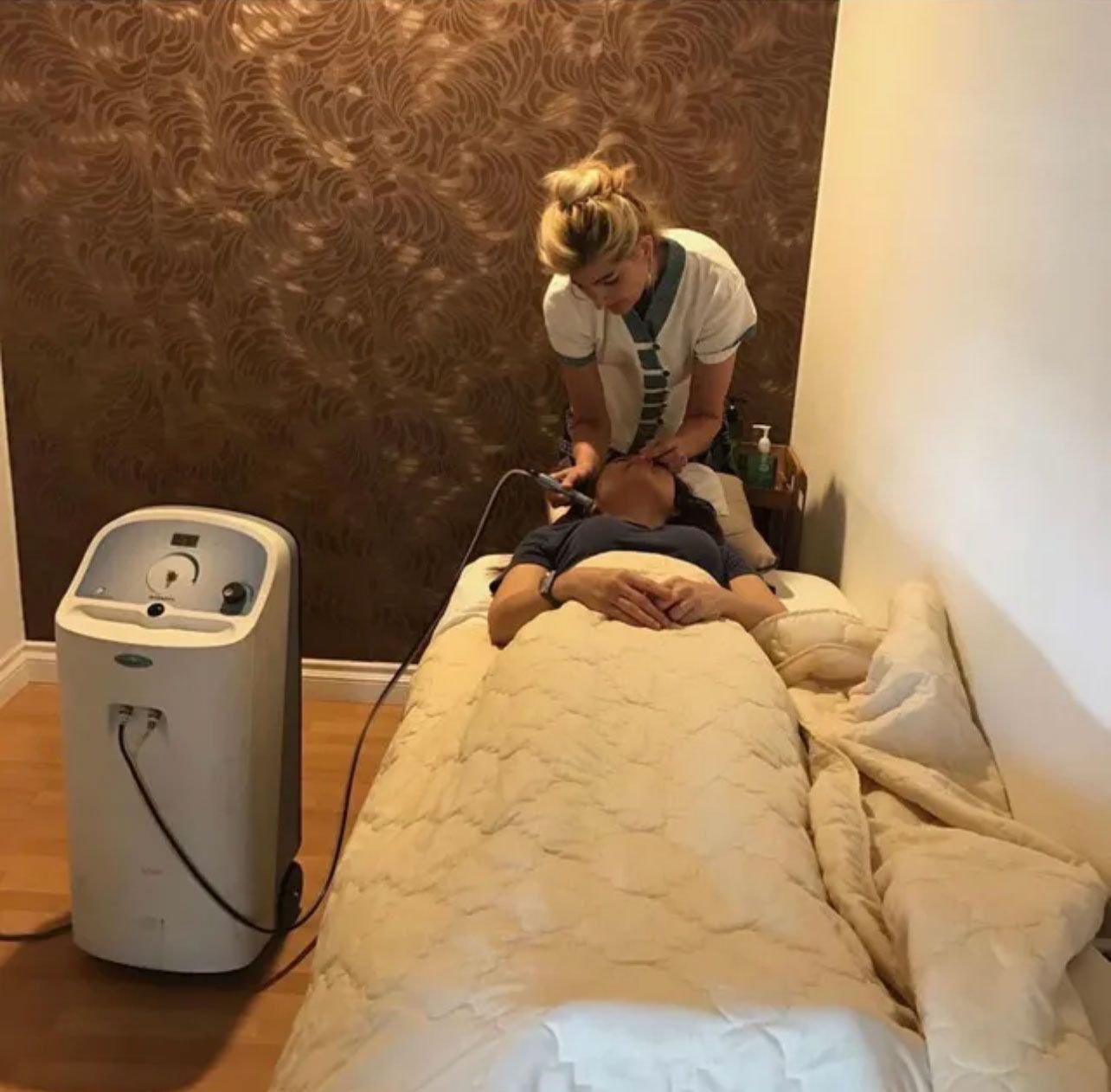 a woman is giving facial service