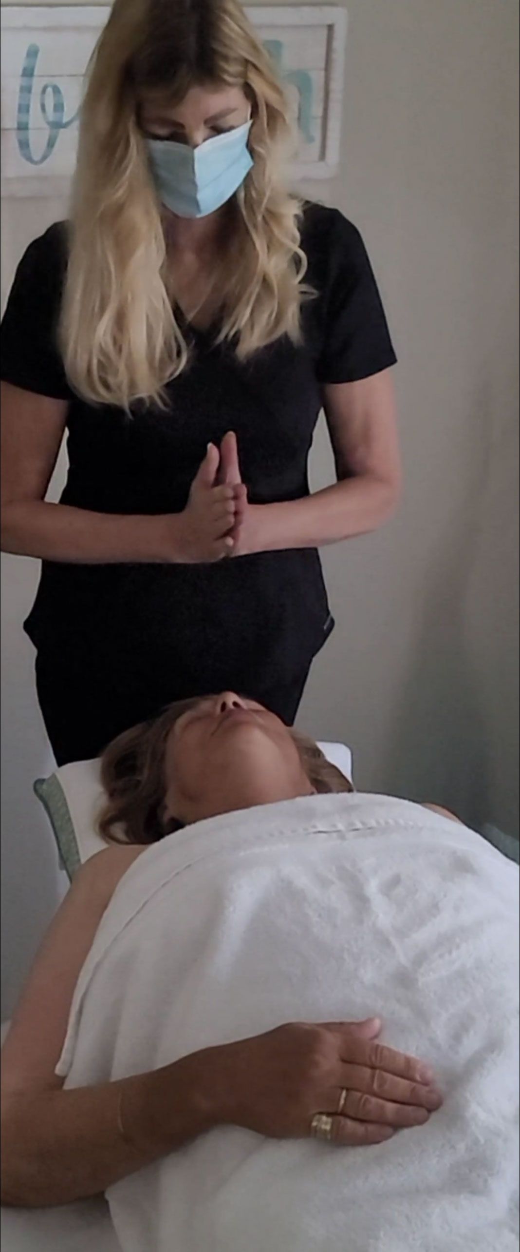 a woman is giving a facial service