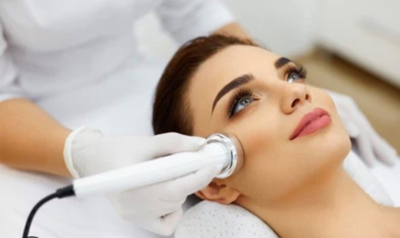A woman is getting a facial treatment at a beauty salon.