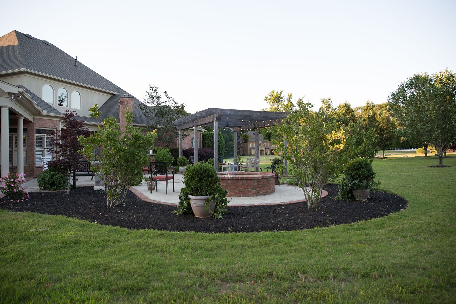 A large house with a fire pit in front of it