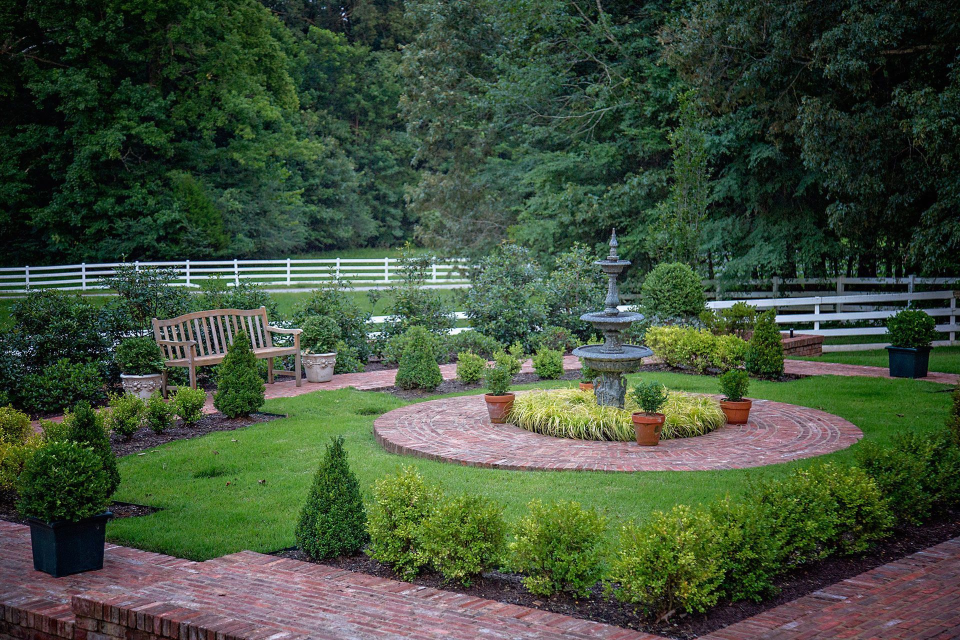 there is a fountain in the middle of the garden .