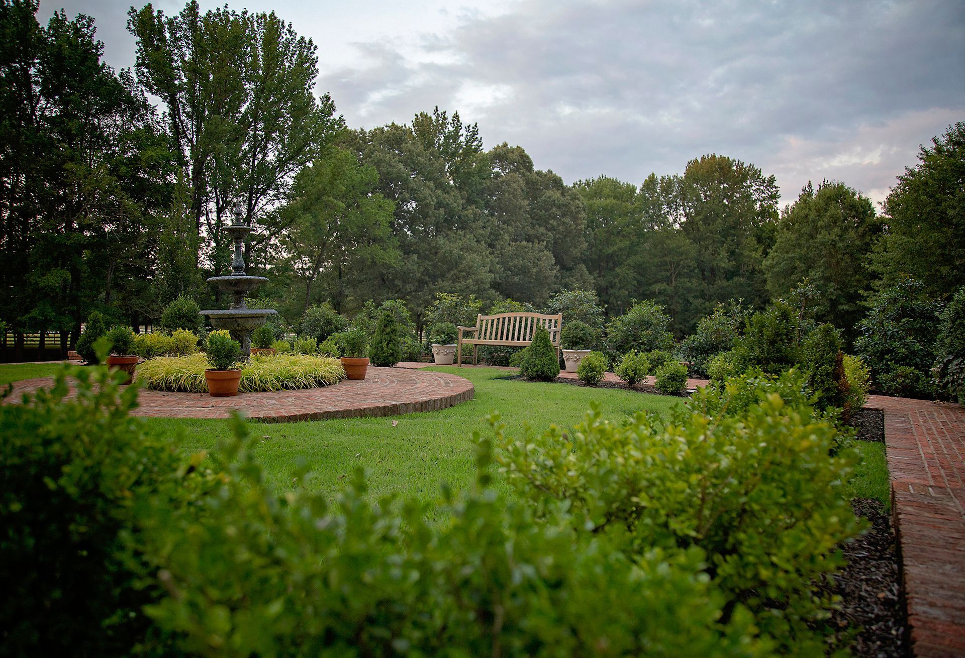 there is a fountain in the middle of the garden .