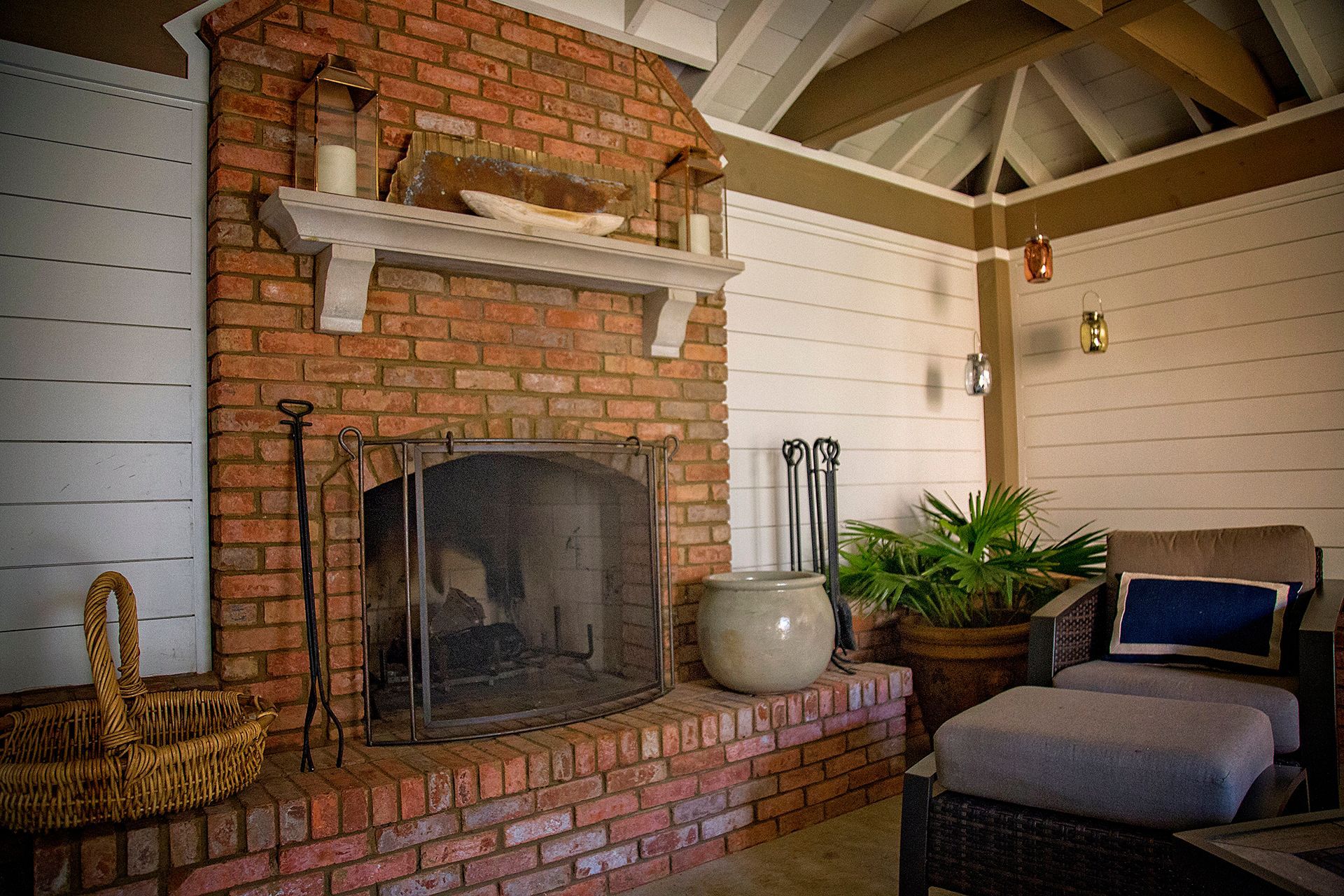 there is a brick fireplace in the middle of the room .
