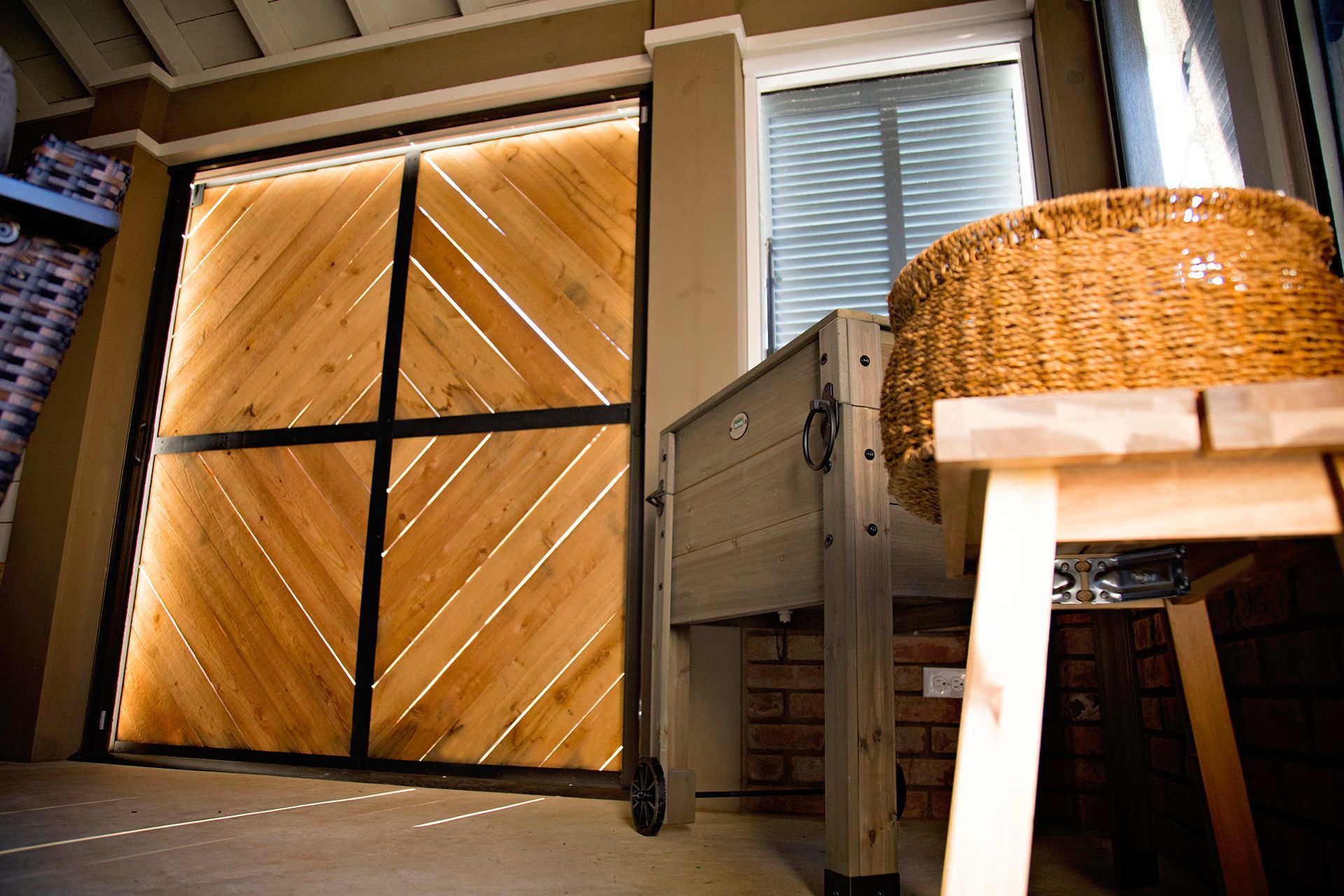 a wicker basket sits on a wooden stool in front of a wooden door .