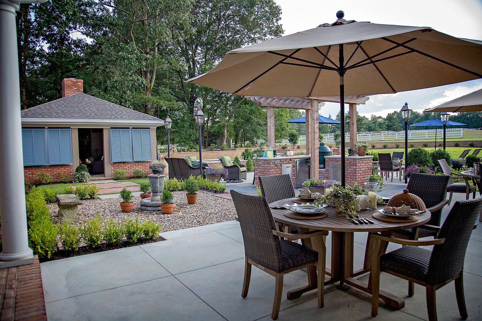 a table and chairs under an umbrella on a patio