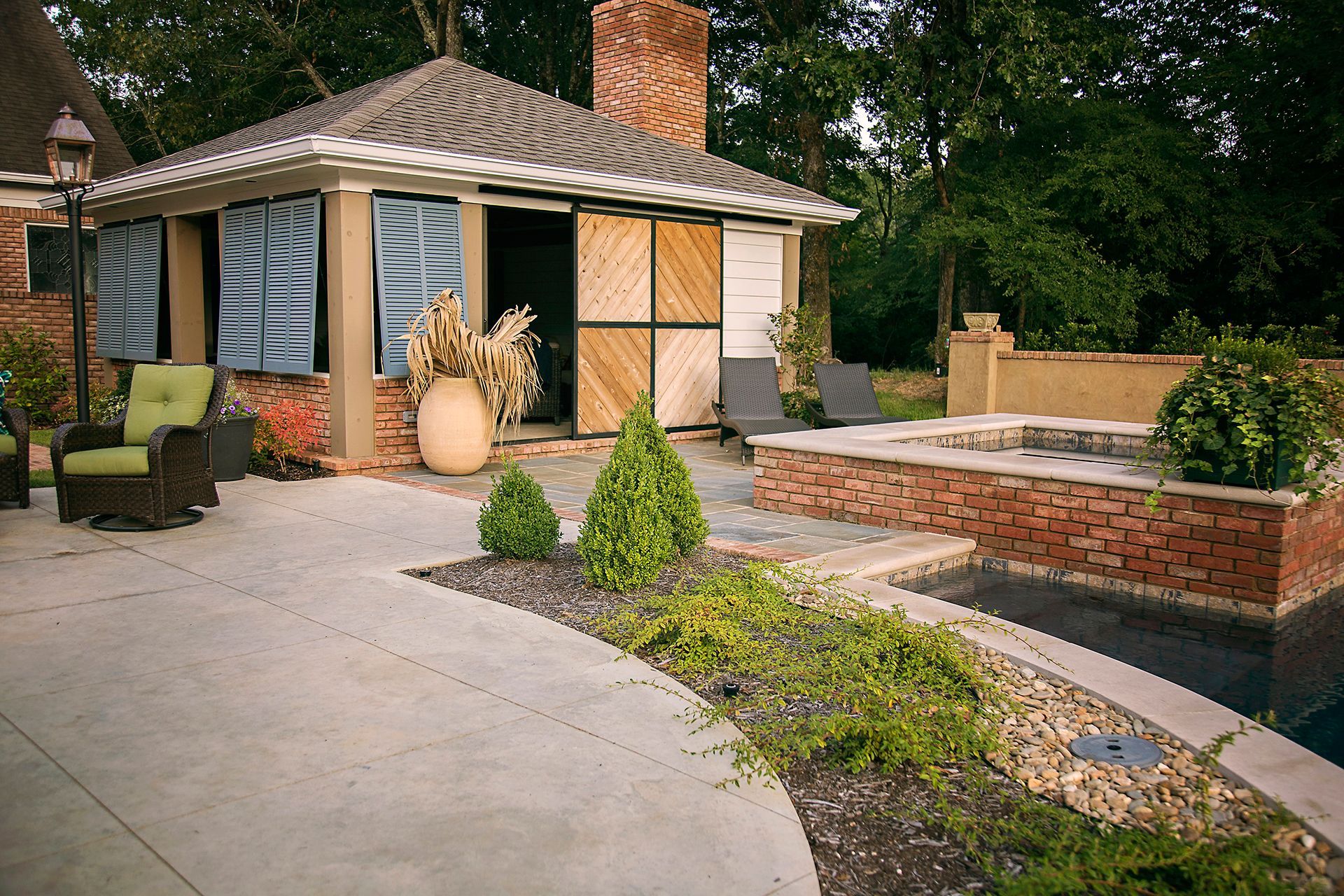 a patio with chairs and a gazebo in the background