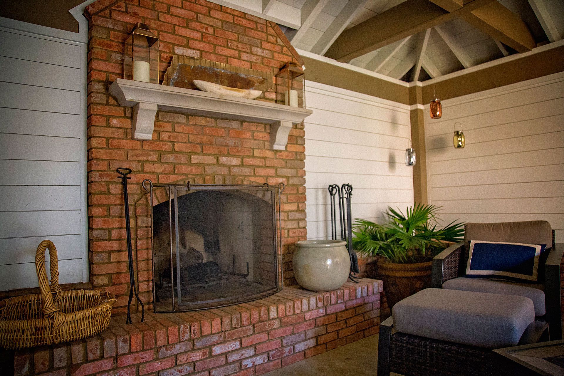 a brick fireplace in an outdoor living area .