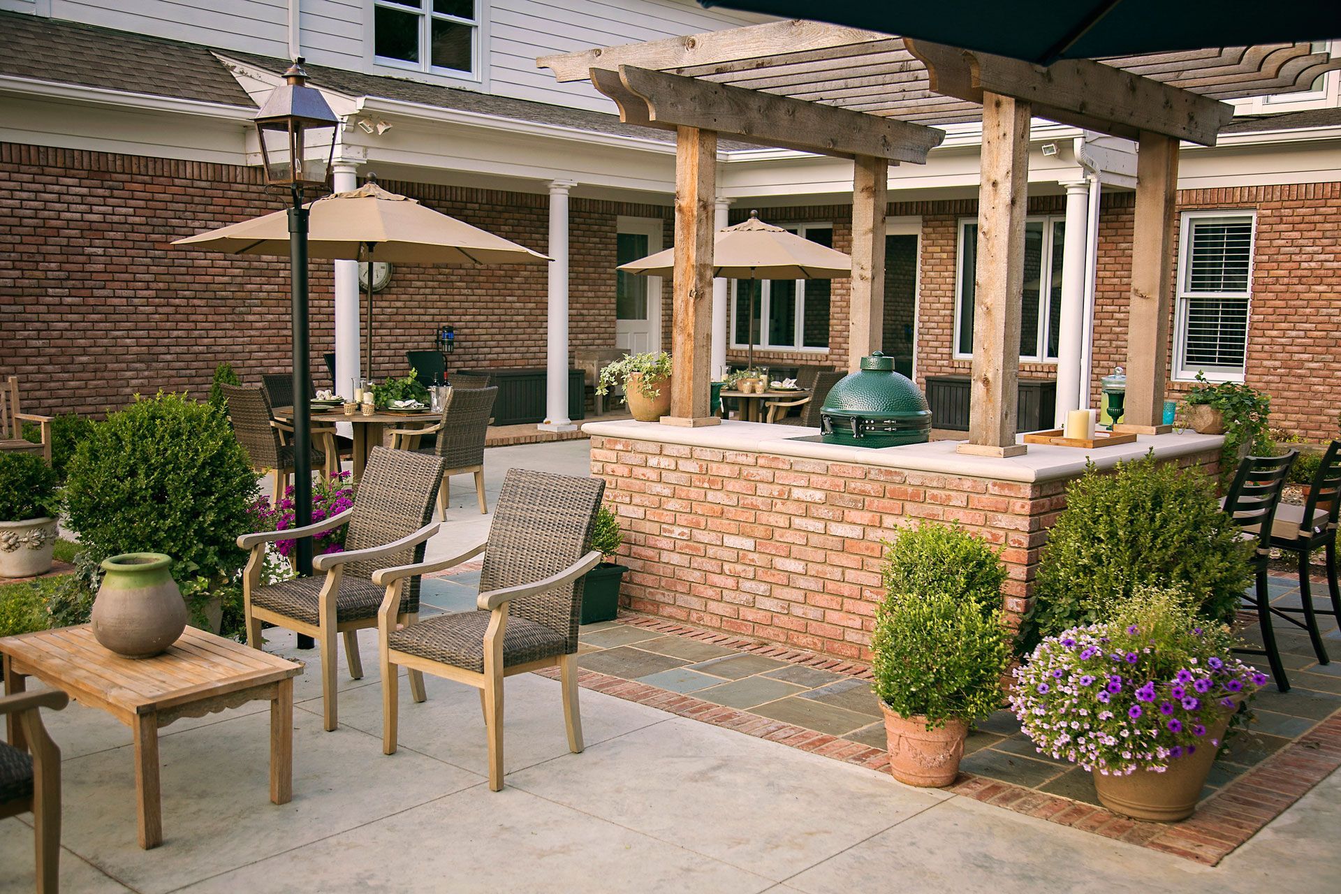 a patio with chairs , tables and umbrellas