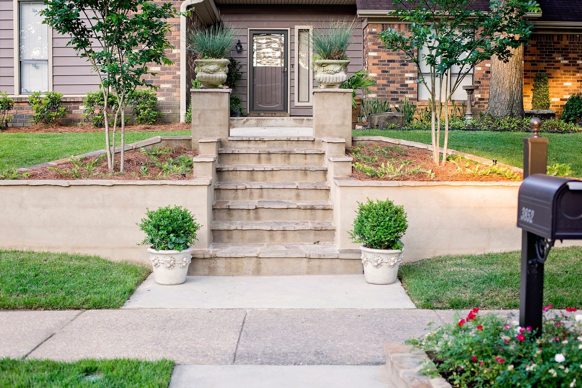 a house with stairs and a mailbox in front of it