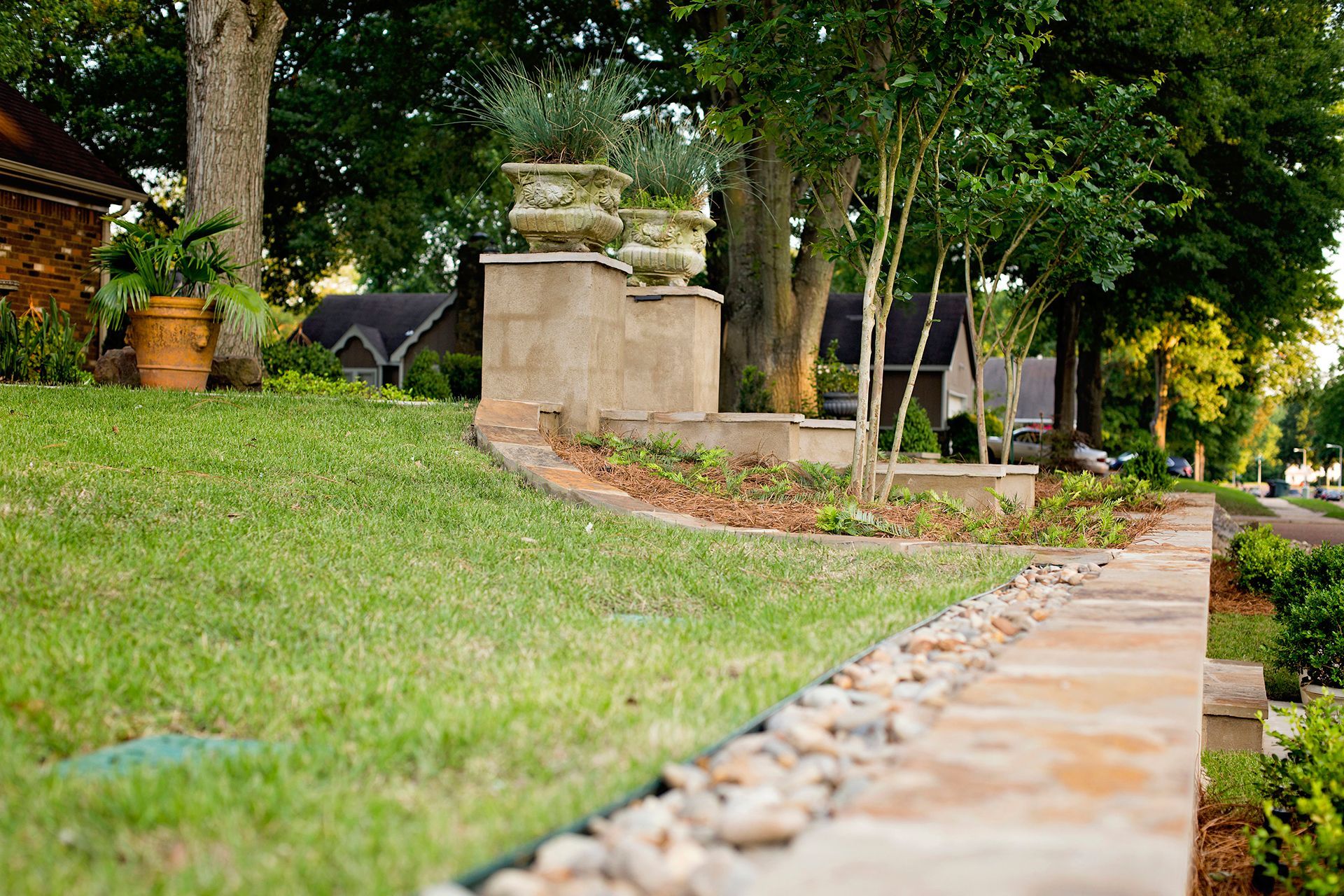 a stone walkway leading to a house in a residential area .