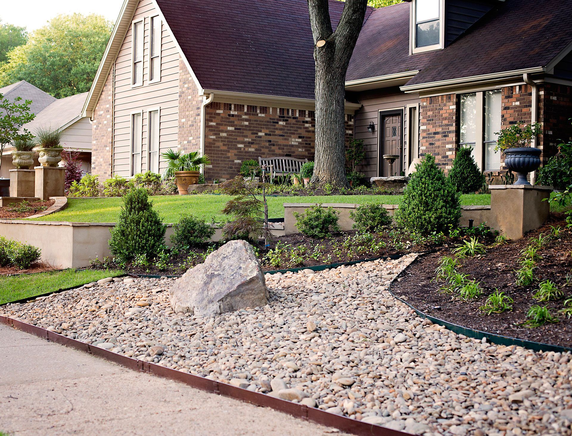 a house with a rock garden in front of it