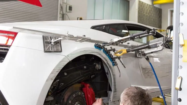 A car with a lot of tools attached to it.