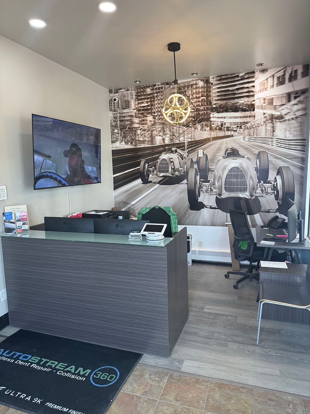 There is a picture of a race car on the wall behind the counter.